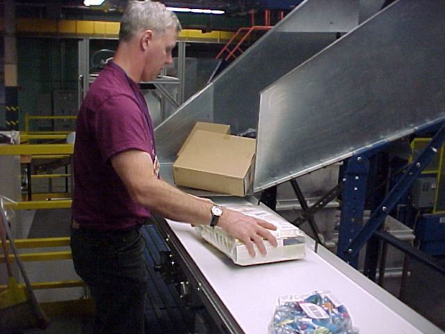 Worker manually inducting packages